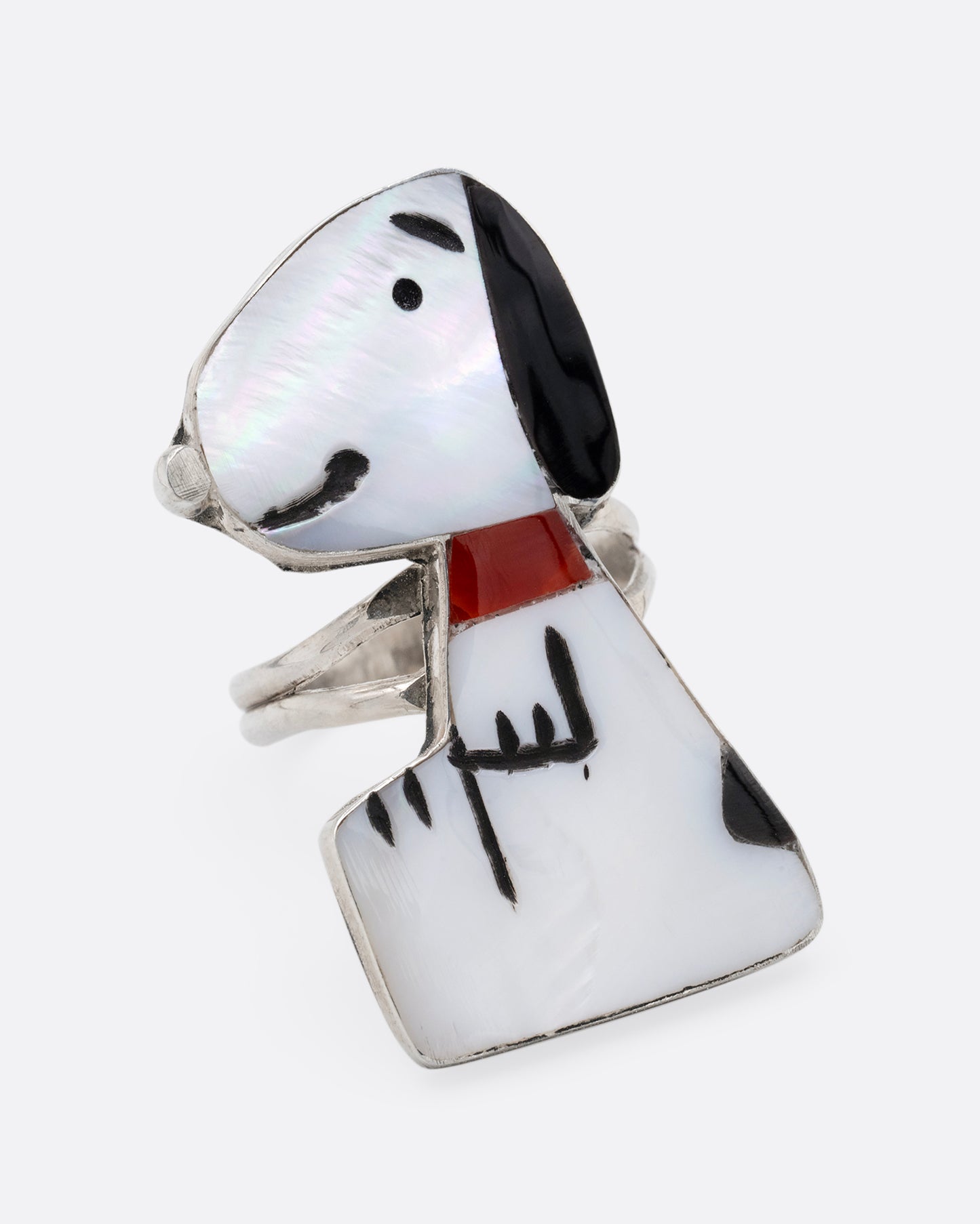 A silver Zunitoon style Snoopy ring made of iridescent mother of pearl and coral inlay. Shown from the front.