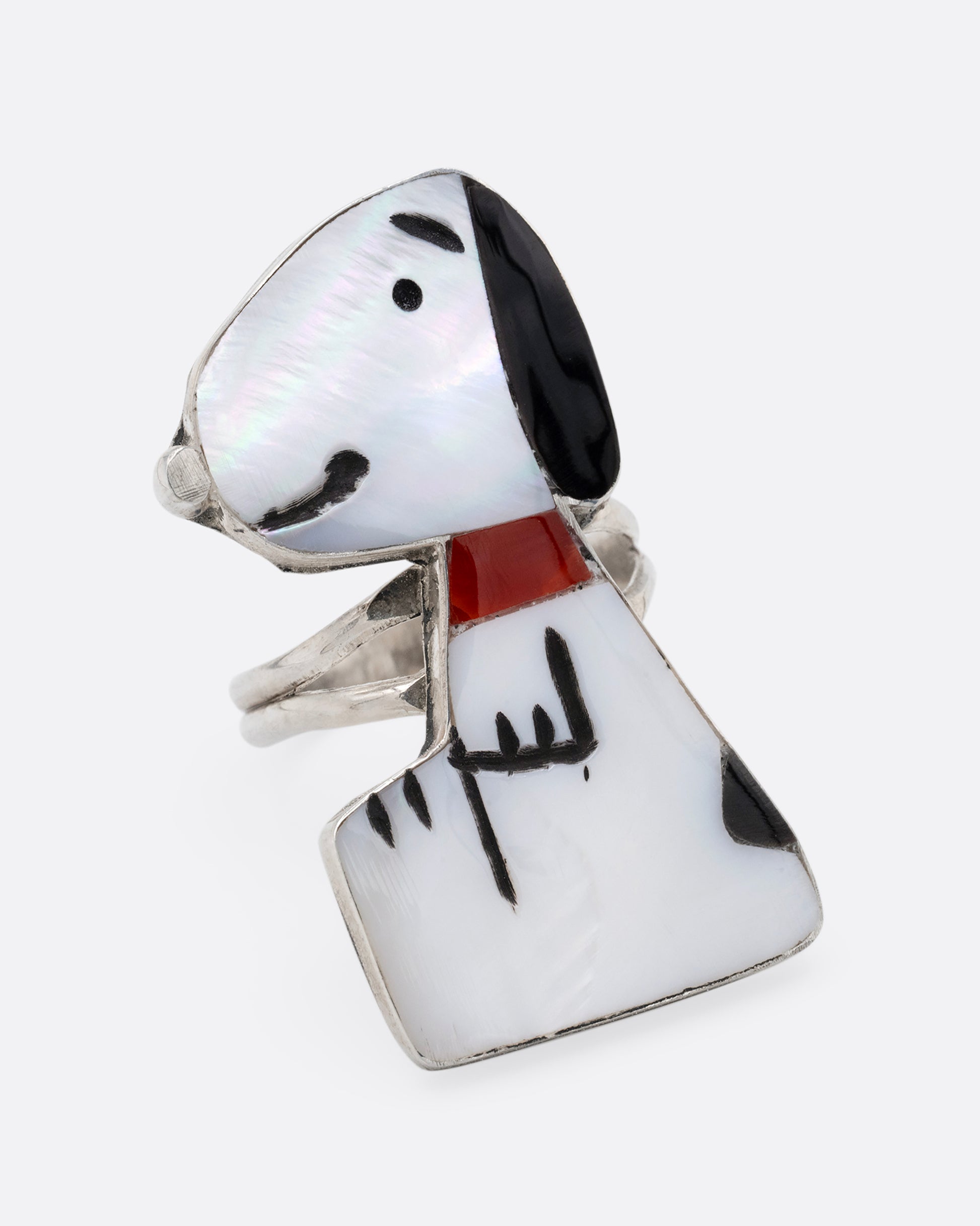 A silver Zunitoon style Snoopy ring made of iridescent mother of pearl and coral inlay. Shown from the front.