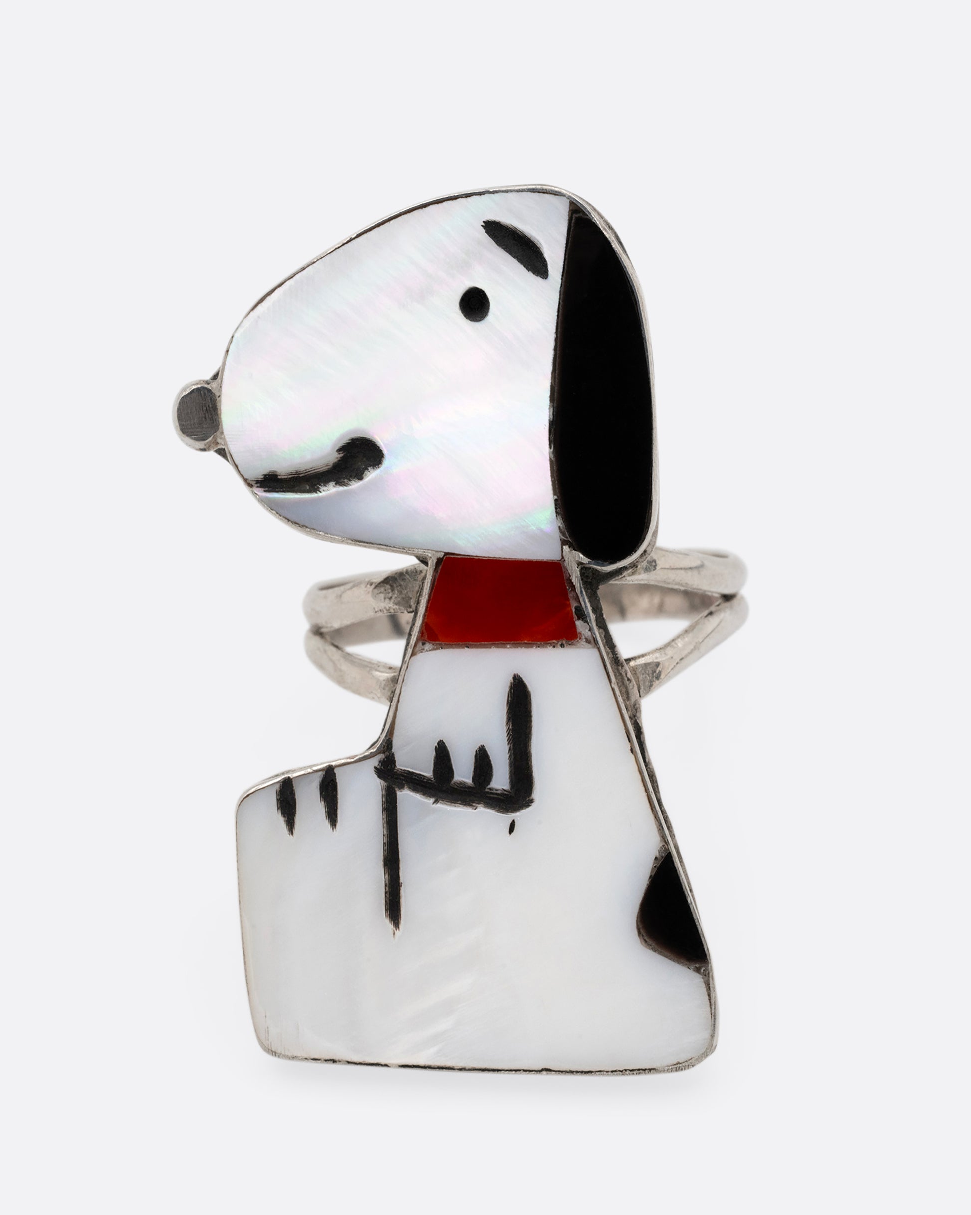 A silver Zunitoon style Snoopy ring made of iridescent mother of pearl and coral inlay. Shown from the front.