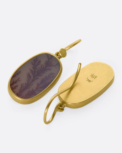 Yellow gold dendritic agate drop earrings, the pair laid flat, one from the front and one from the back