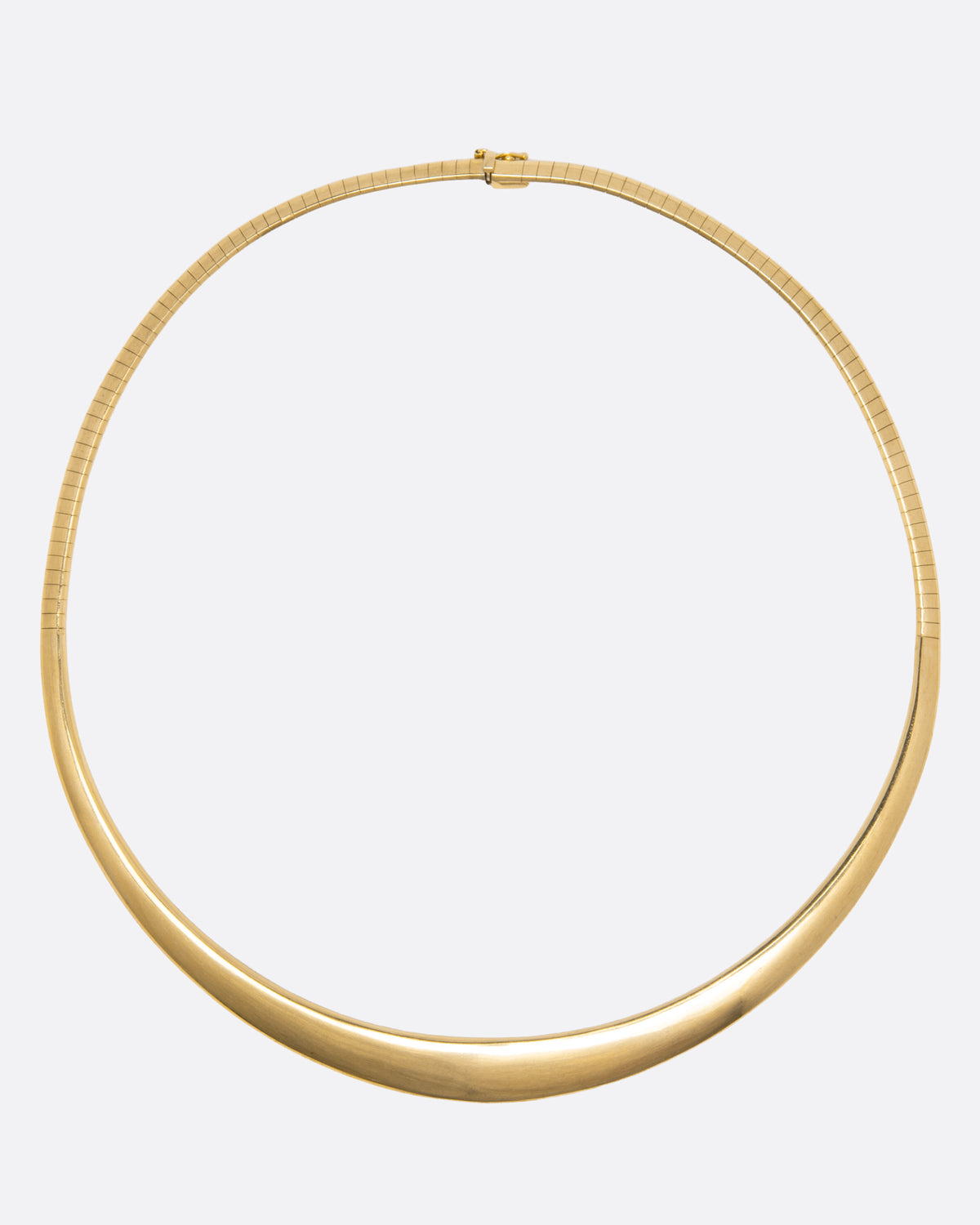 A yellow gold collar necklace with graduated width and a safety closure, shown from above laying flat.