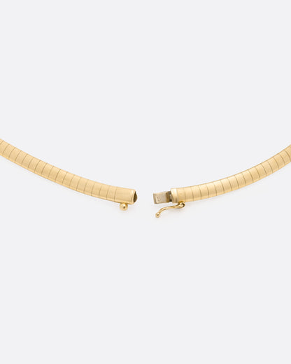 Vintage yellow gold omega collar necklace, close view of the clasp opened, showing the box clasp and safety catch