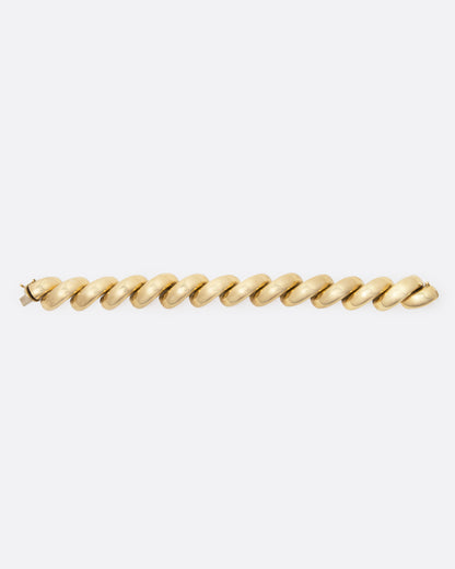 Vintage yellow gold twist bracelet laid out flat, showing the full length of the links