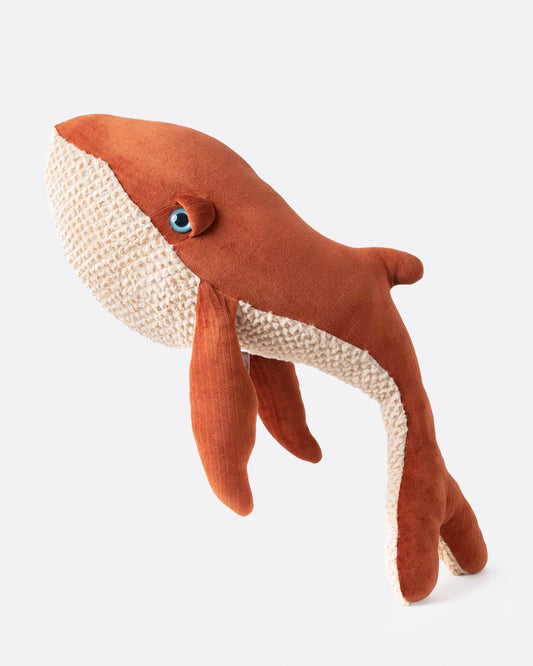 Large stuffed whale in rust-red velvet with a cream knit belly, side view
