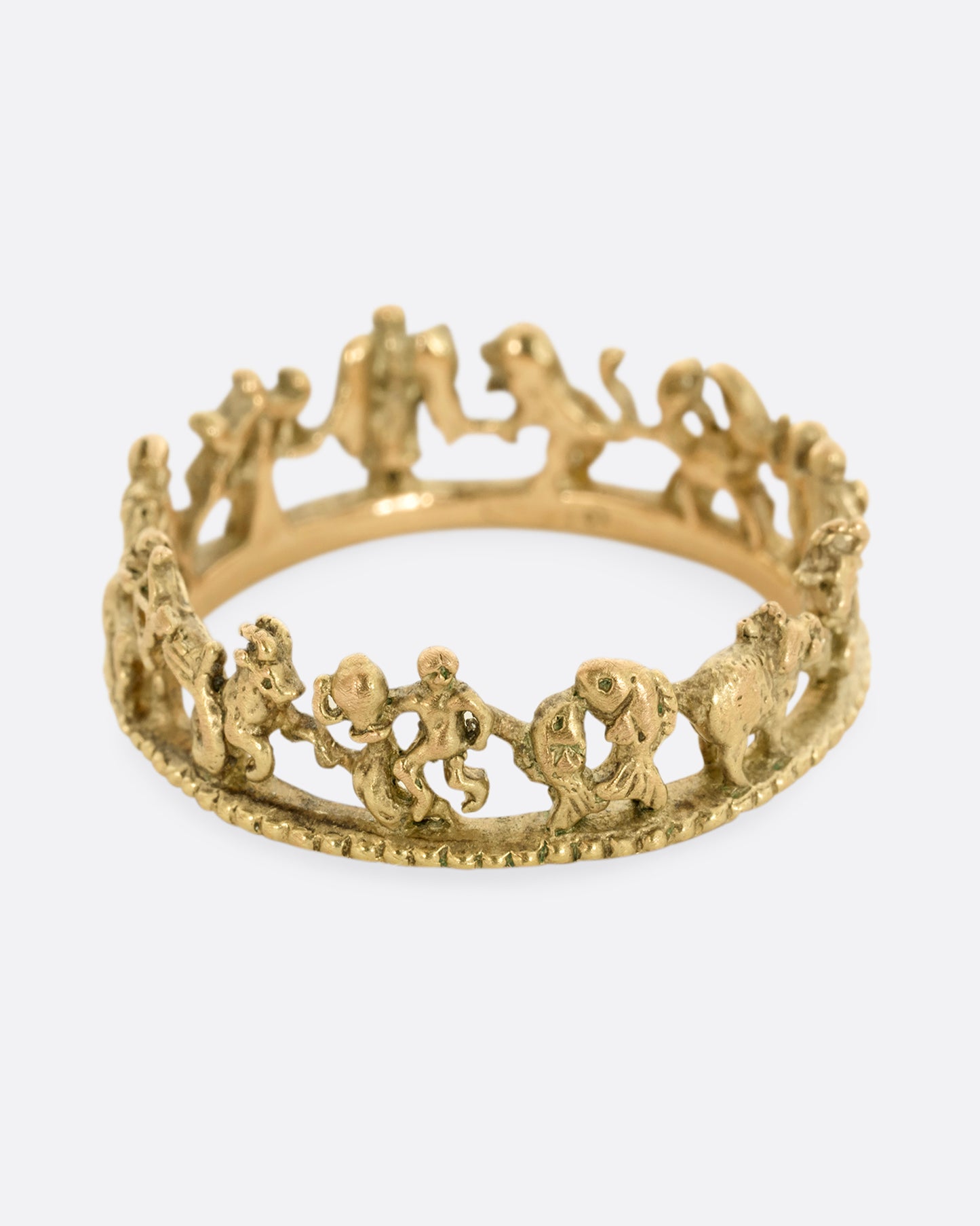 A yellow gold ring with every zodiac character around the entire band.