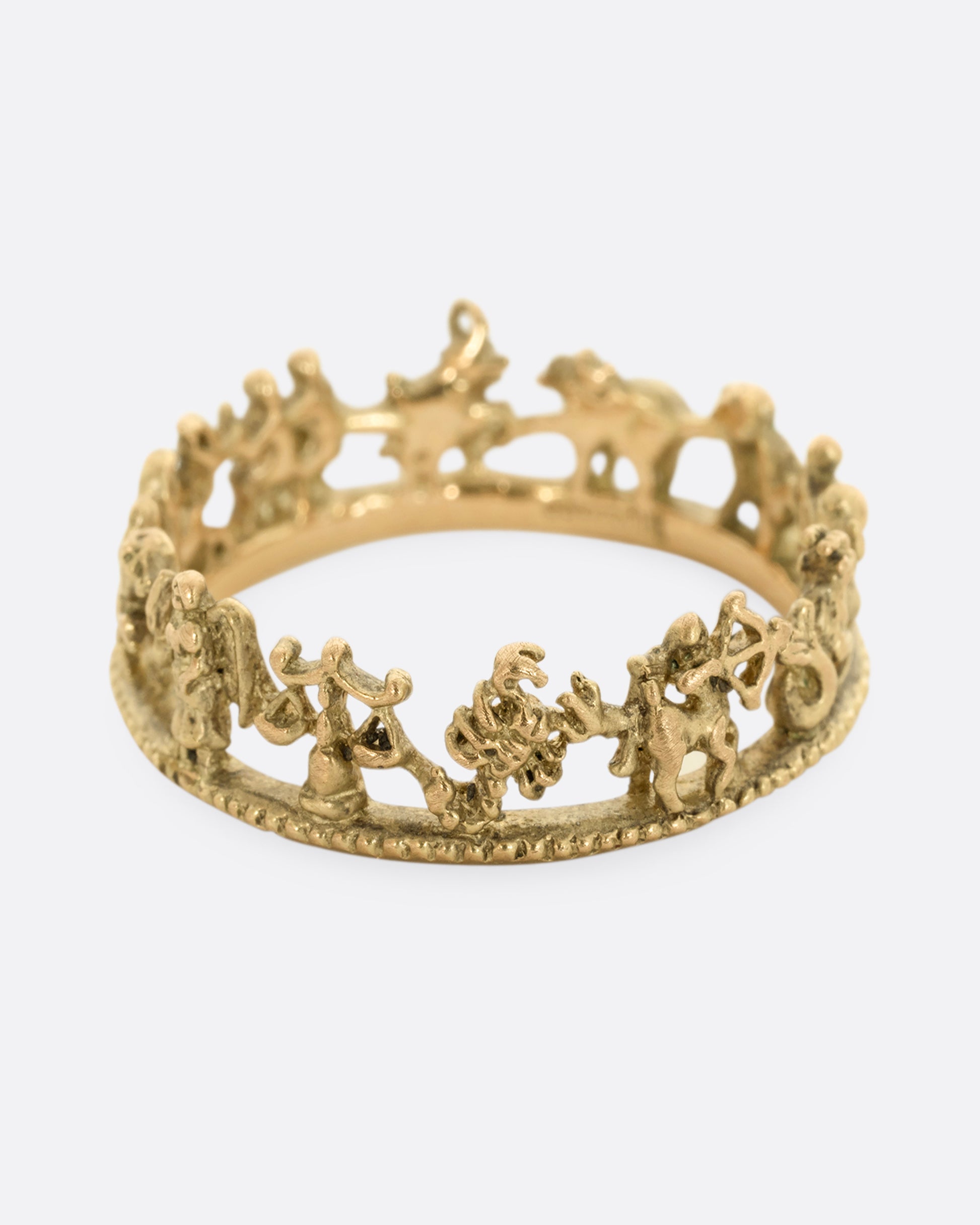 A yellow gold ring with every zodiac character around the entire band.