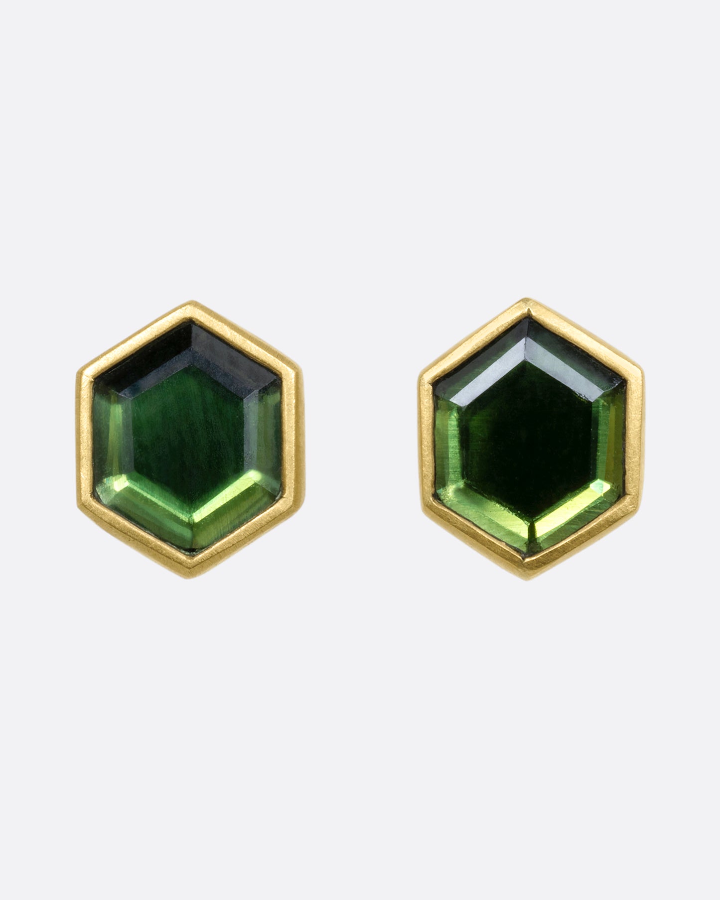 Yellow gold hexagon studs with bezel set green chrome tourmaline. View from the front.