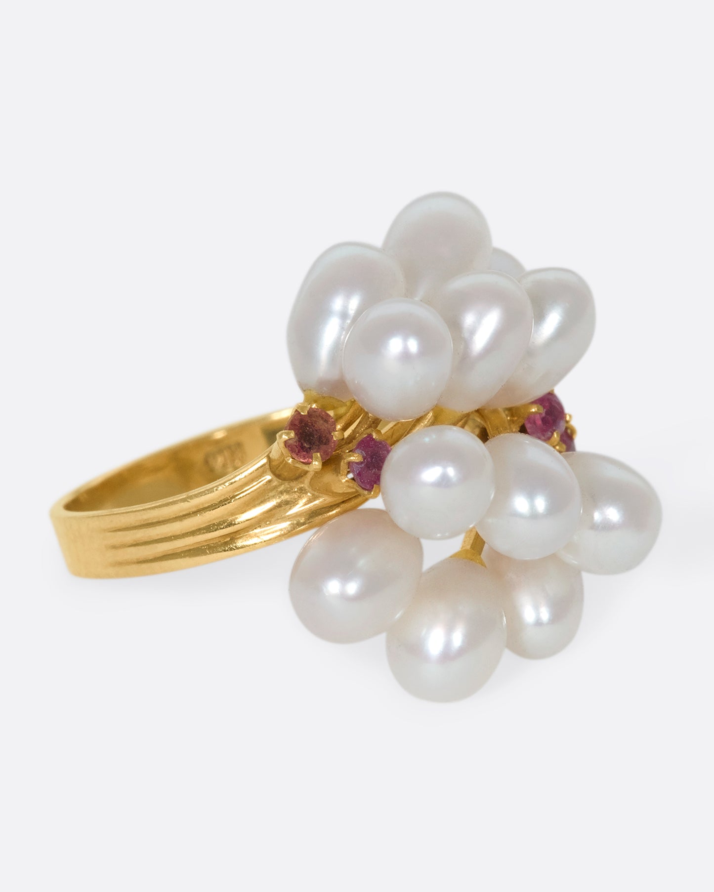 A 14k gold and pearl pussy willow ring with pink sapphire accents. Silky pearls wave across your finger like blossoms, adding beautiful dimension to your finger.