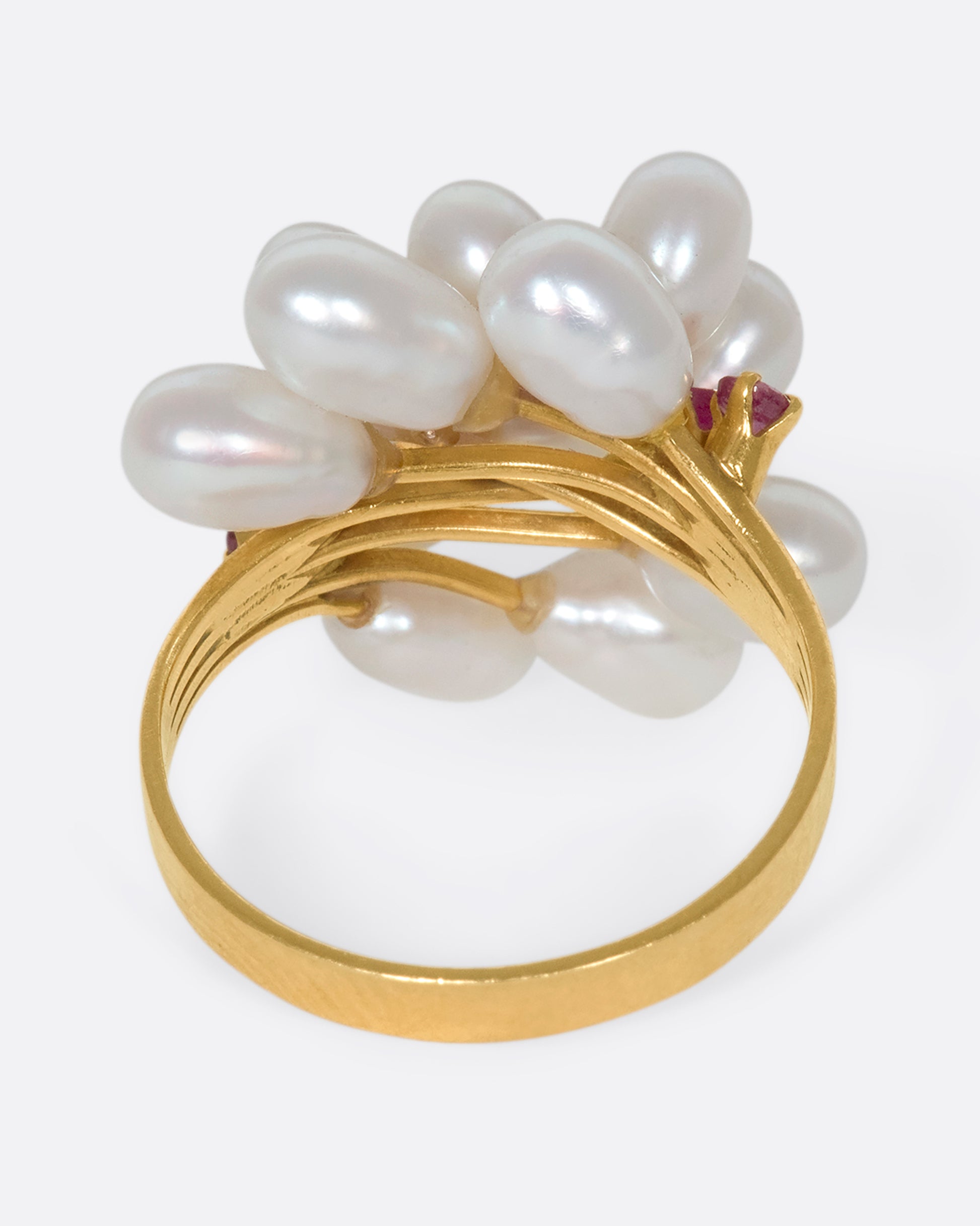 A 14k gold and pearl pussy willow ring with pink sapphire accents. Silky pearls wave across your finger like blossoms, adding beautiful dimension to your finger.