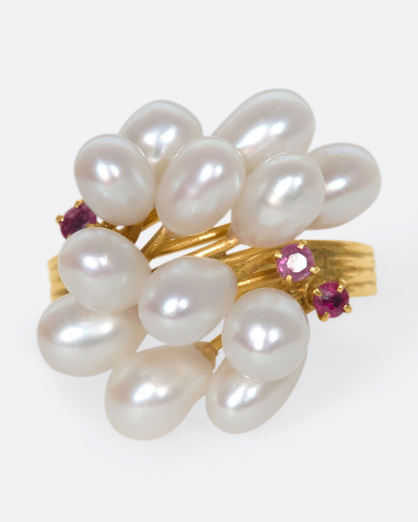 A 14k gold and pearl pussy willow ring with pink sapphire accents. Silky pearls wave across your finger like blossoms, adding beautiful dimension to your finger.