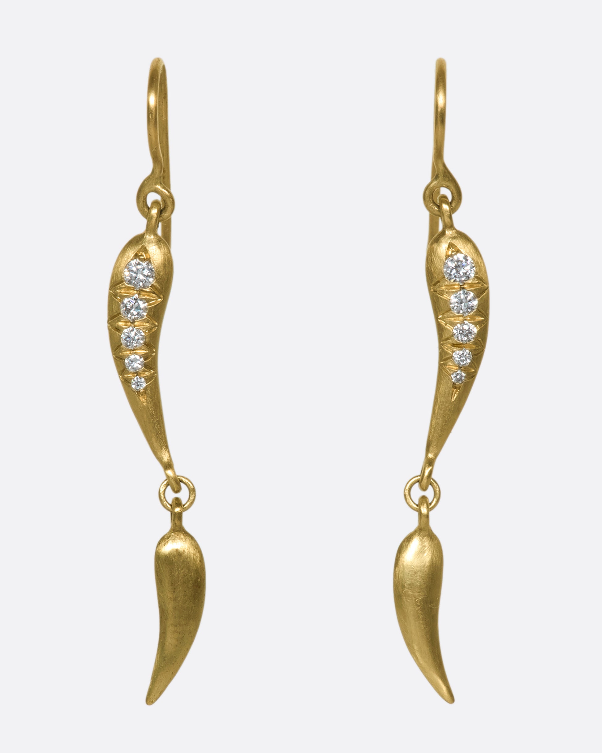 Gold drop earrings with 2 curved segments on each side, two of which have 5 diamonds.