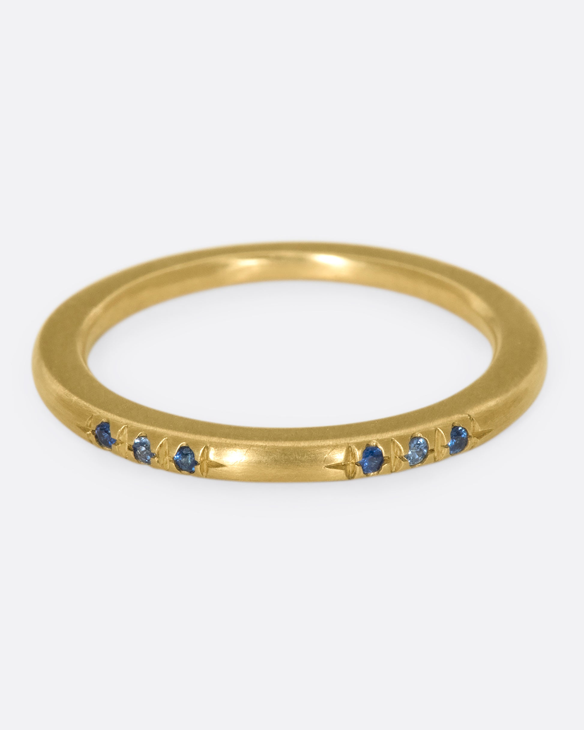 A 10k gold band with light and dark blue sapphires