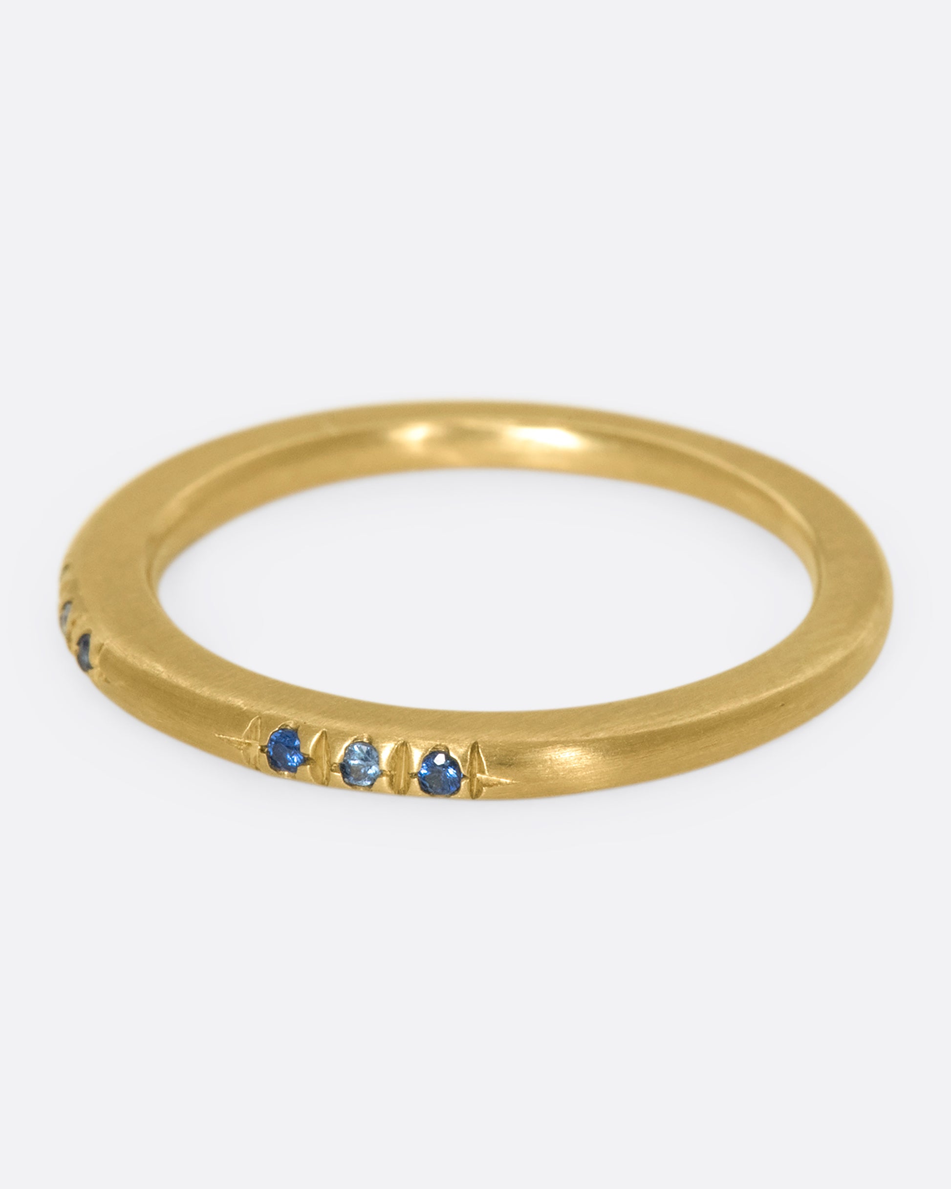 A 10k gold band with light and dark blue sapphires