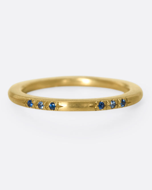 A 10k gold band with light and dark blue sapphires