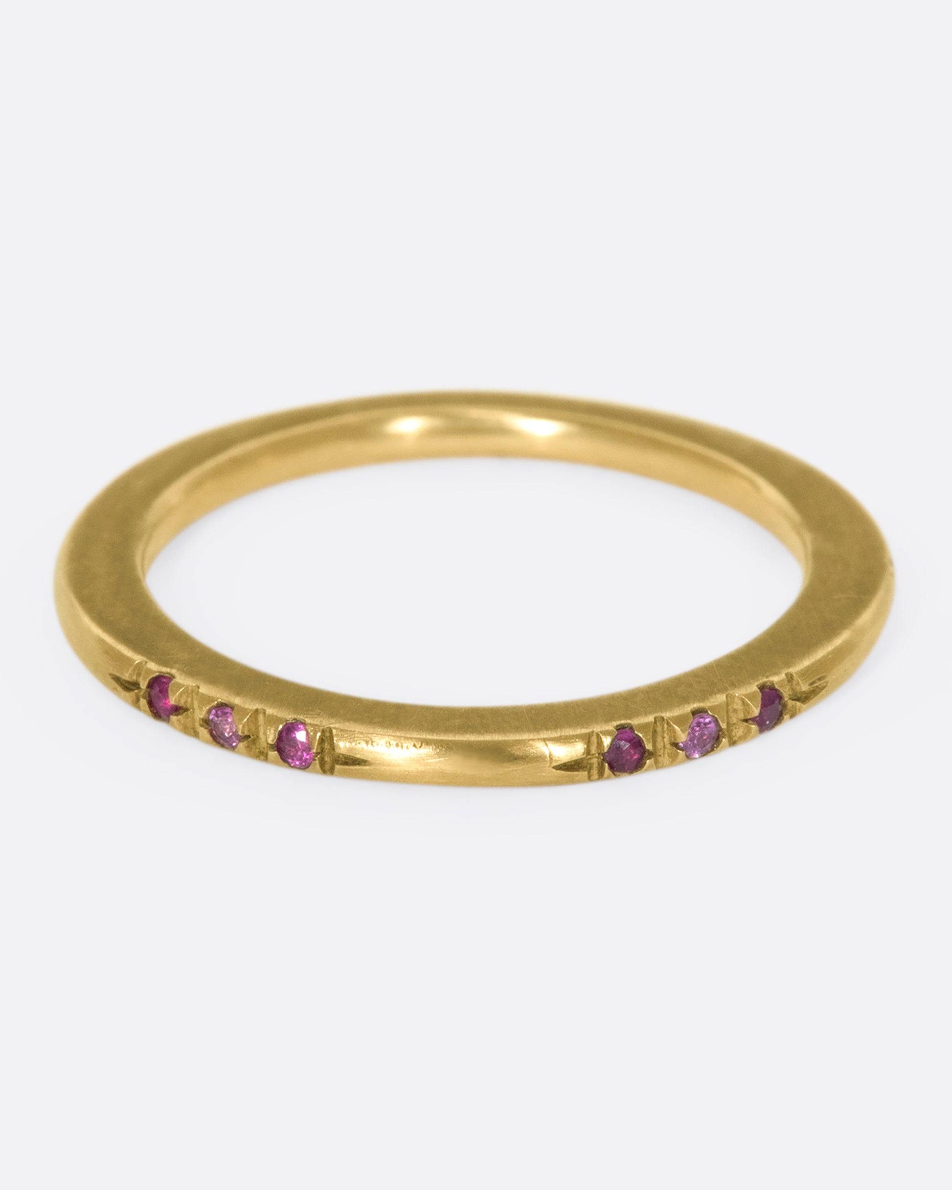 A 10k brushed gold band with rubies and pink sapphires