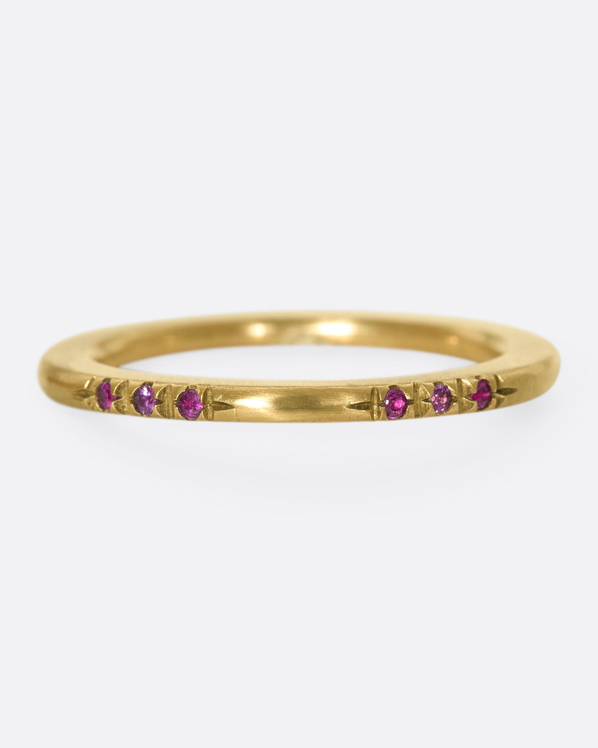 A 10k brushed gold band with rubies and pink sapphires