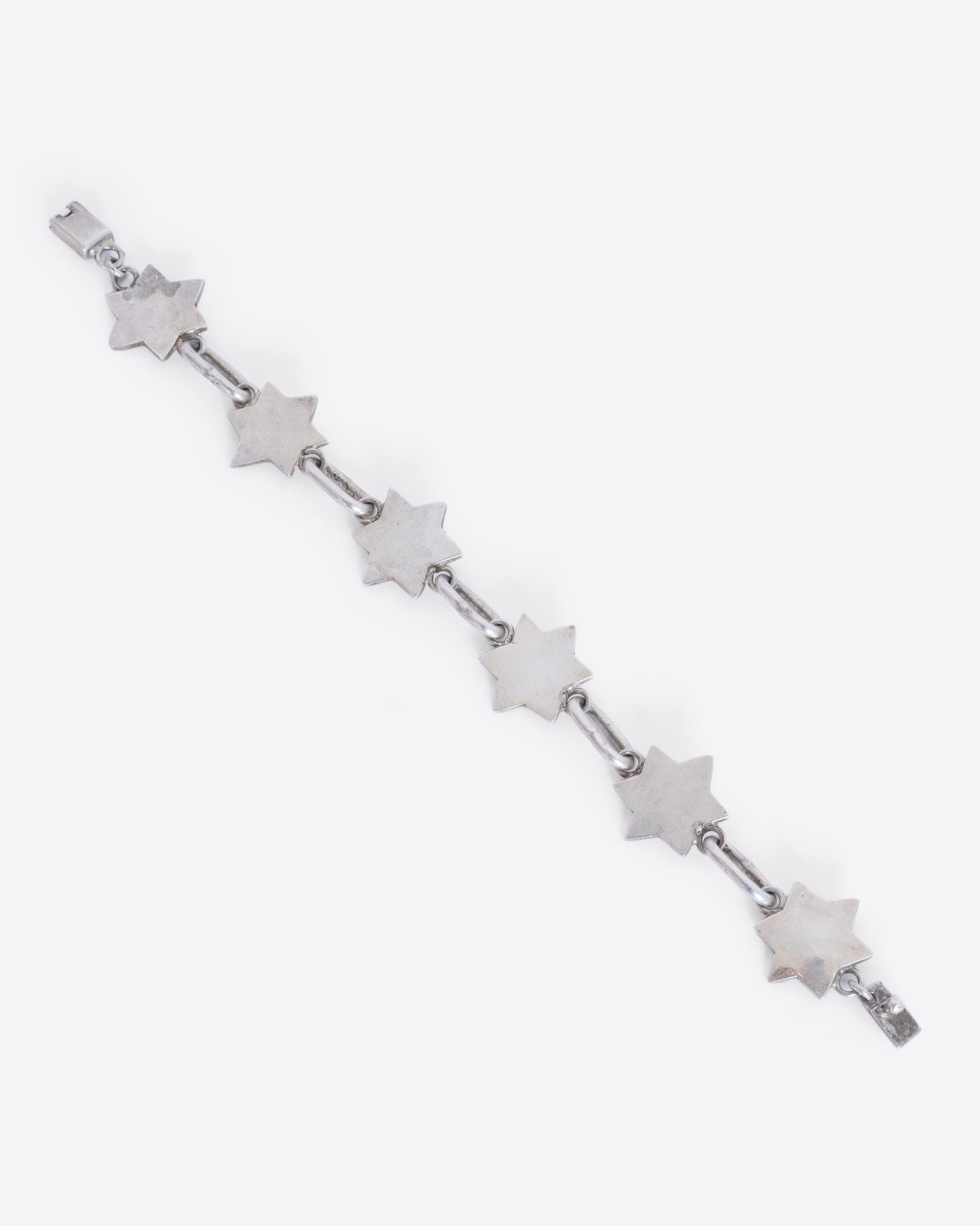 A sterling silver bracelet with star of David links. View laying flat from above.