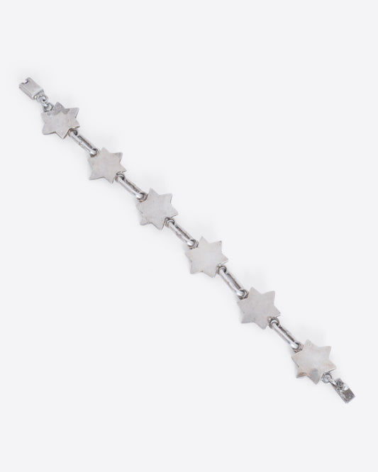 A sterling silver bracelet with star of David links. View laying flat from above.