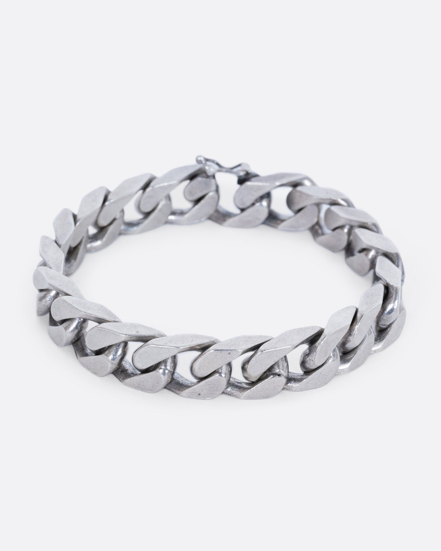 A chunky flat curb chain bracelet. View from the front, closed.