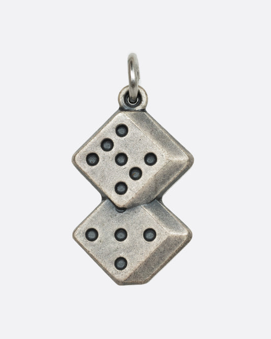 A sterling silver pendant or charm with two dice rolled to a 12. View from the front.