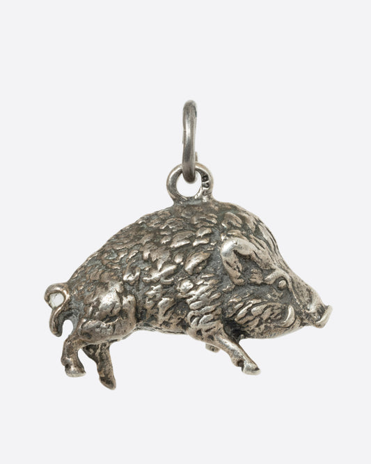 A sterling silver boar charm.