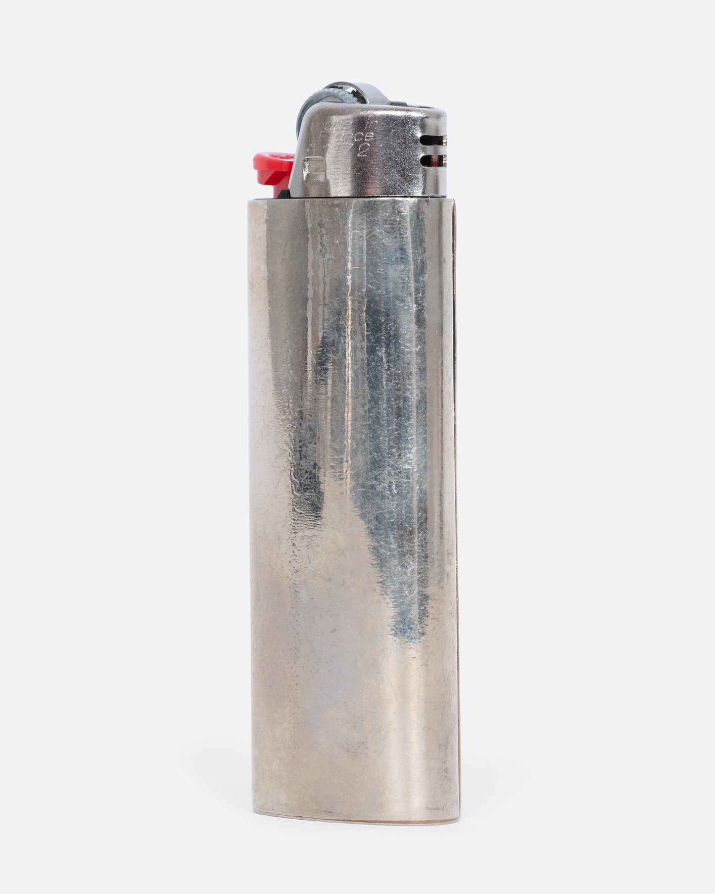 An alpaca silver lighter cover with a unicorn and rainbow. View from the back.