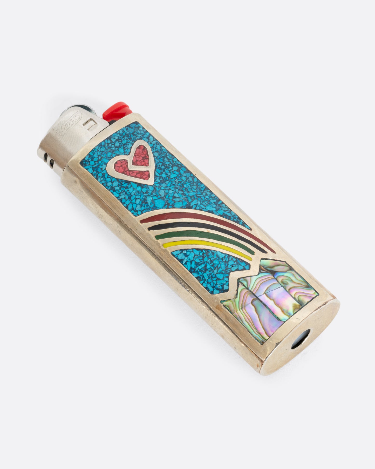 An alpaca silver lighter cover with a rainbow and heart. Shown laying flat.