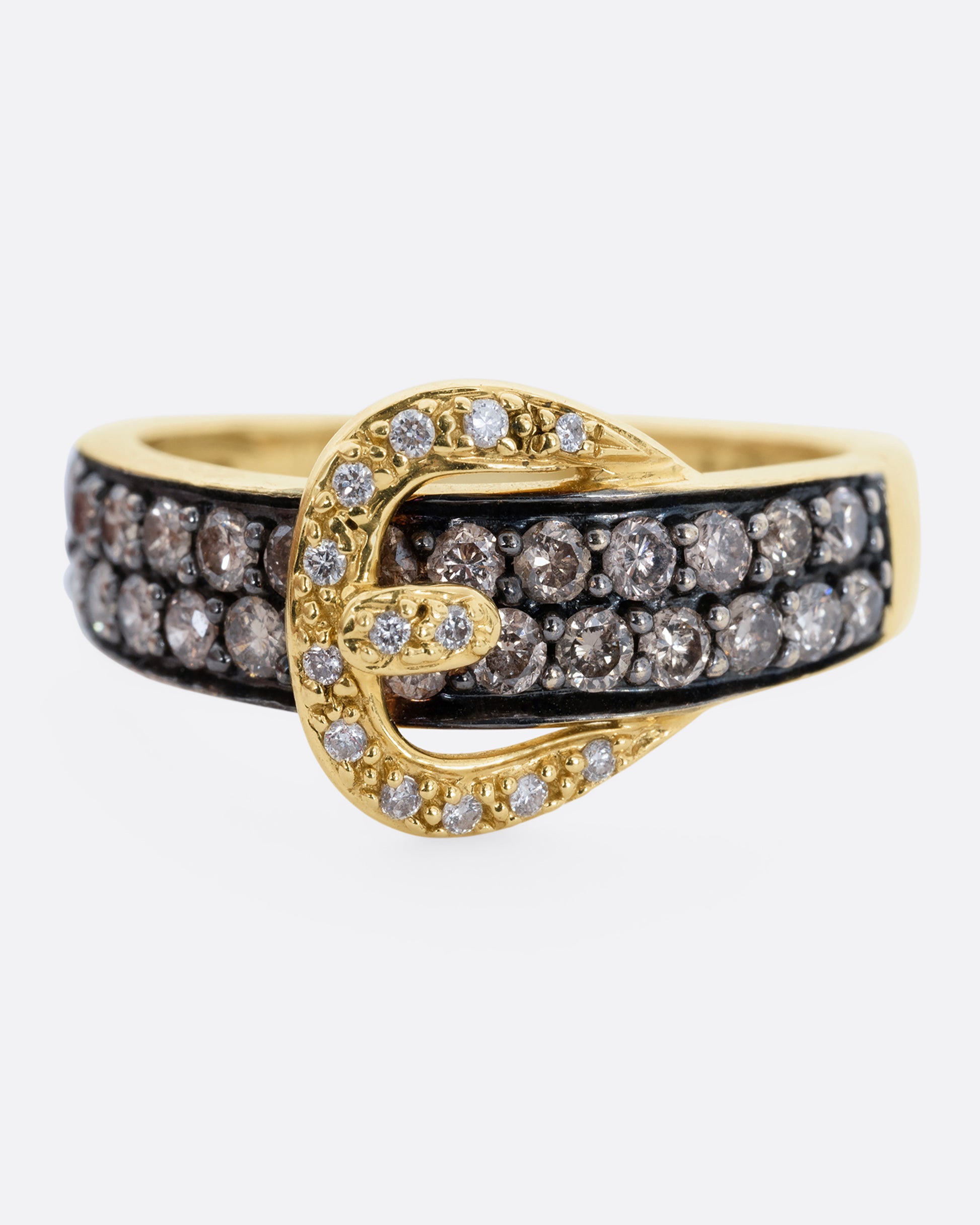 A diamond encrusted black and yellow gold belt buckle ring. View from the front.