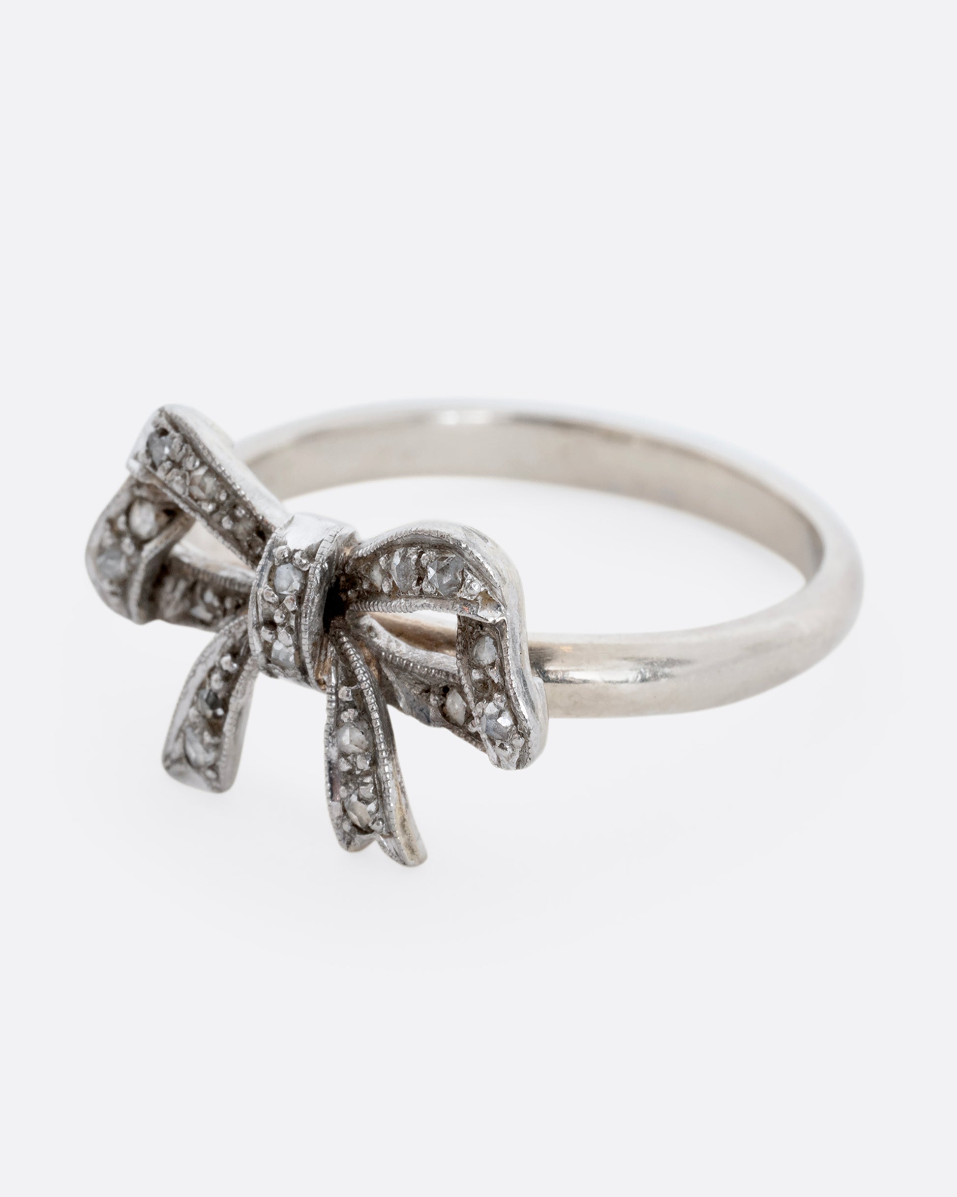 A white gold bow ring with diamonds. View from the alternate side.