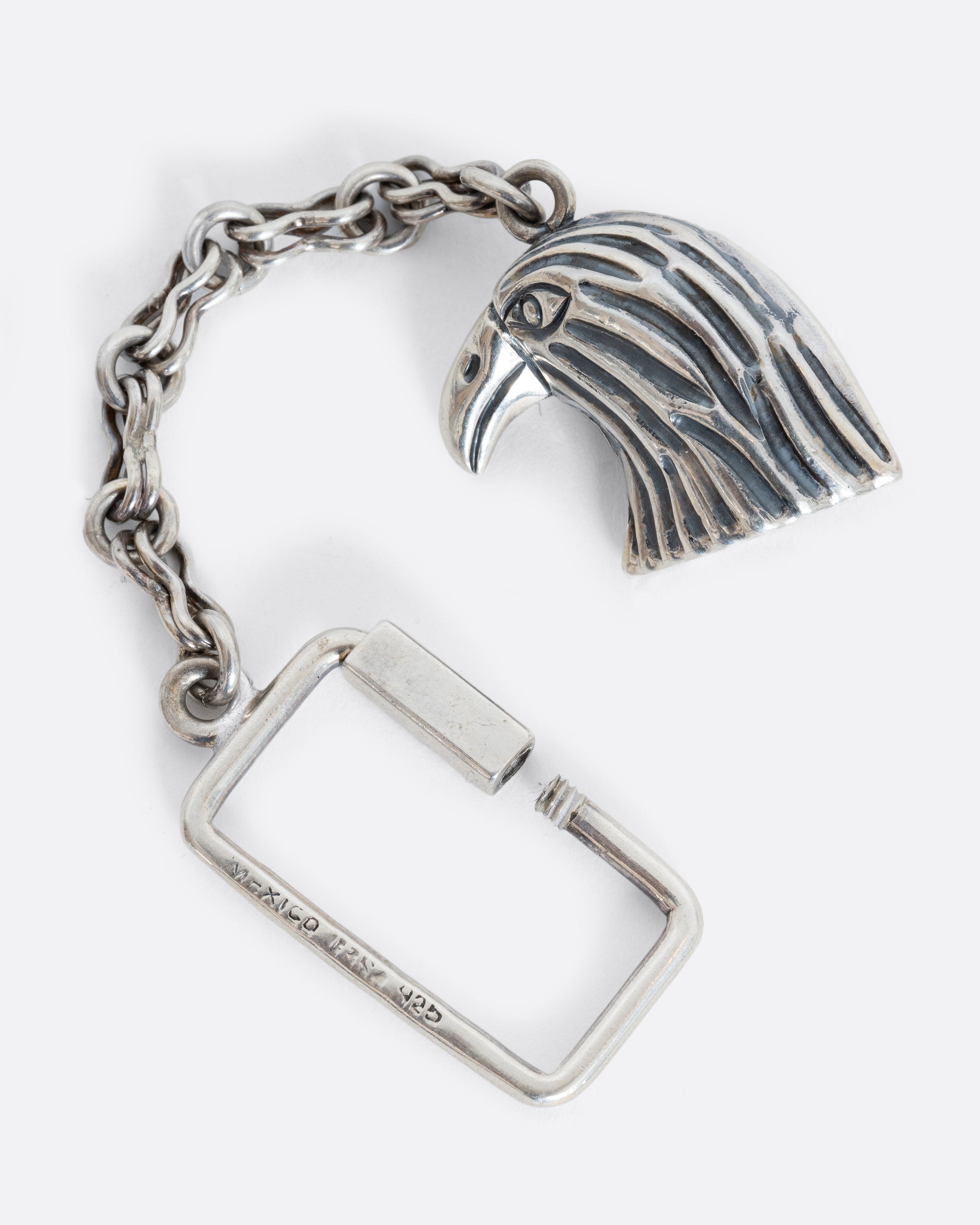 A sterling silver eagle keychain. Shown laying flat.