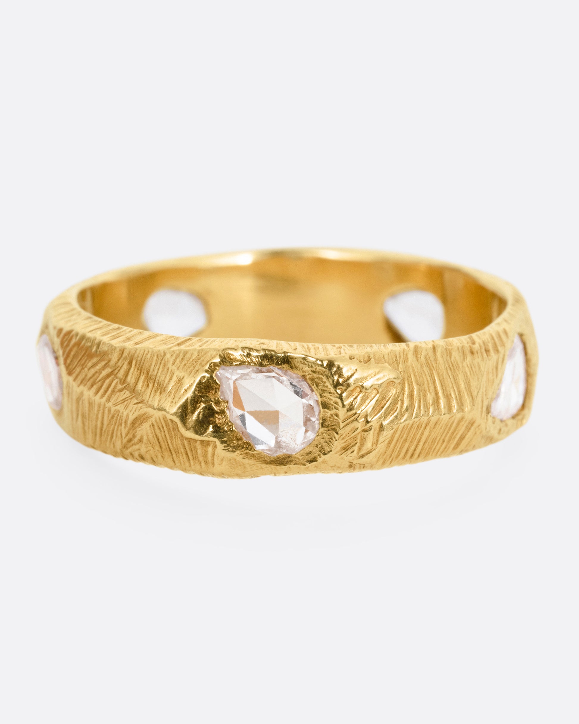 A yellow gold ring with five freeform rose cut diamonds, shown from the front.