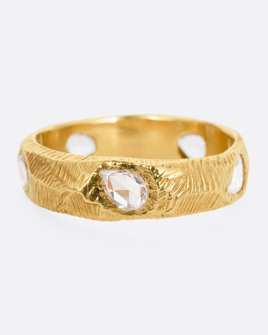 A yellow gold ring with five freeform rose cut diamonds, shown from the front.