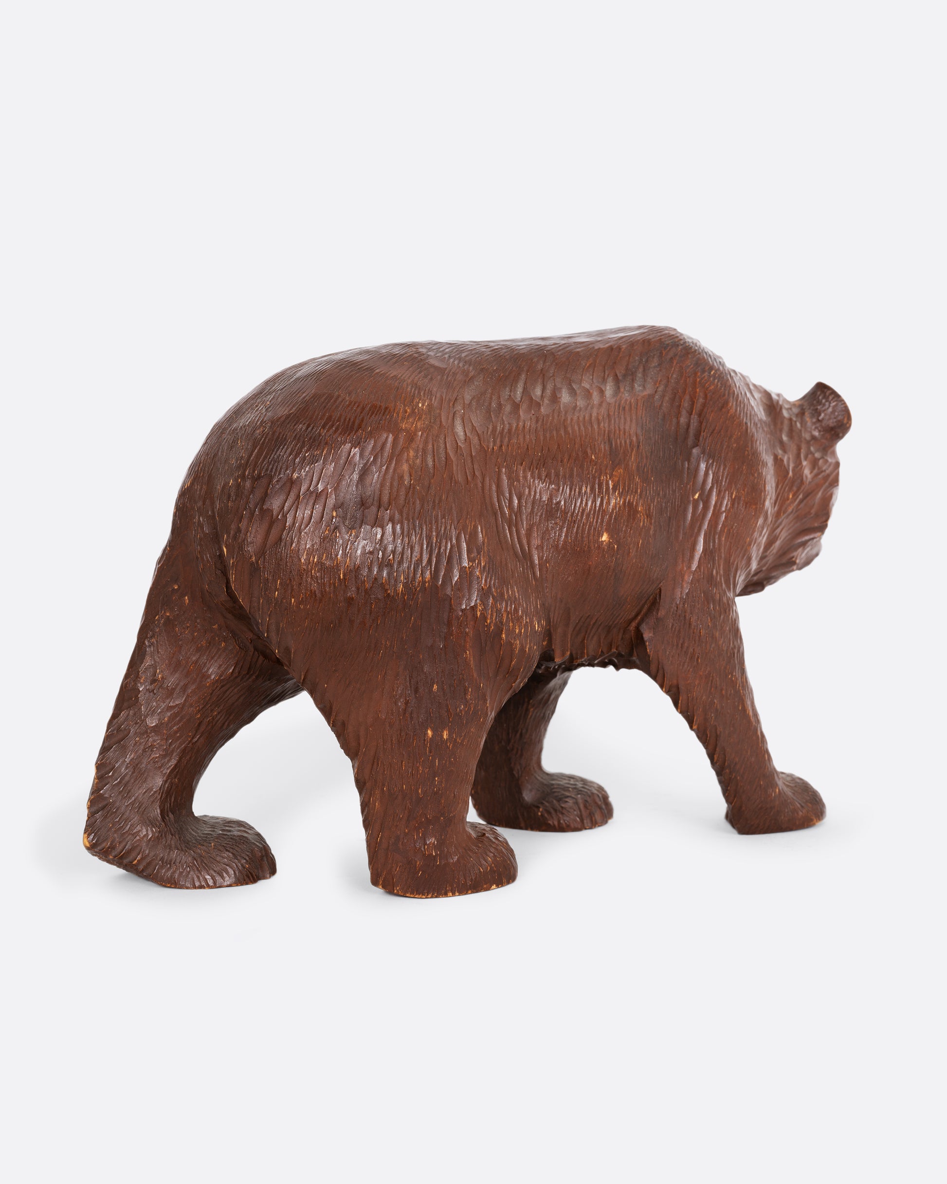 A wooden bear with glass eyes. Shown from the back.