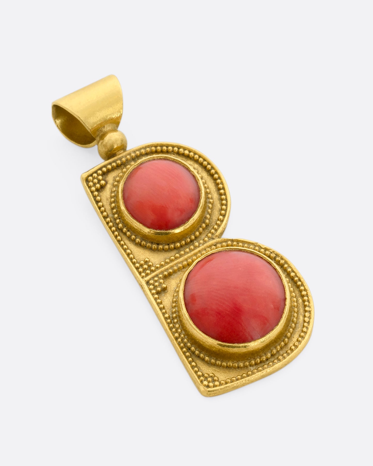 A yellow gold letter "B" pendant with coral circles. View laying flat. 