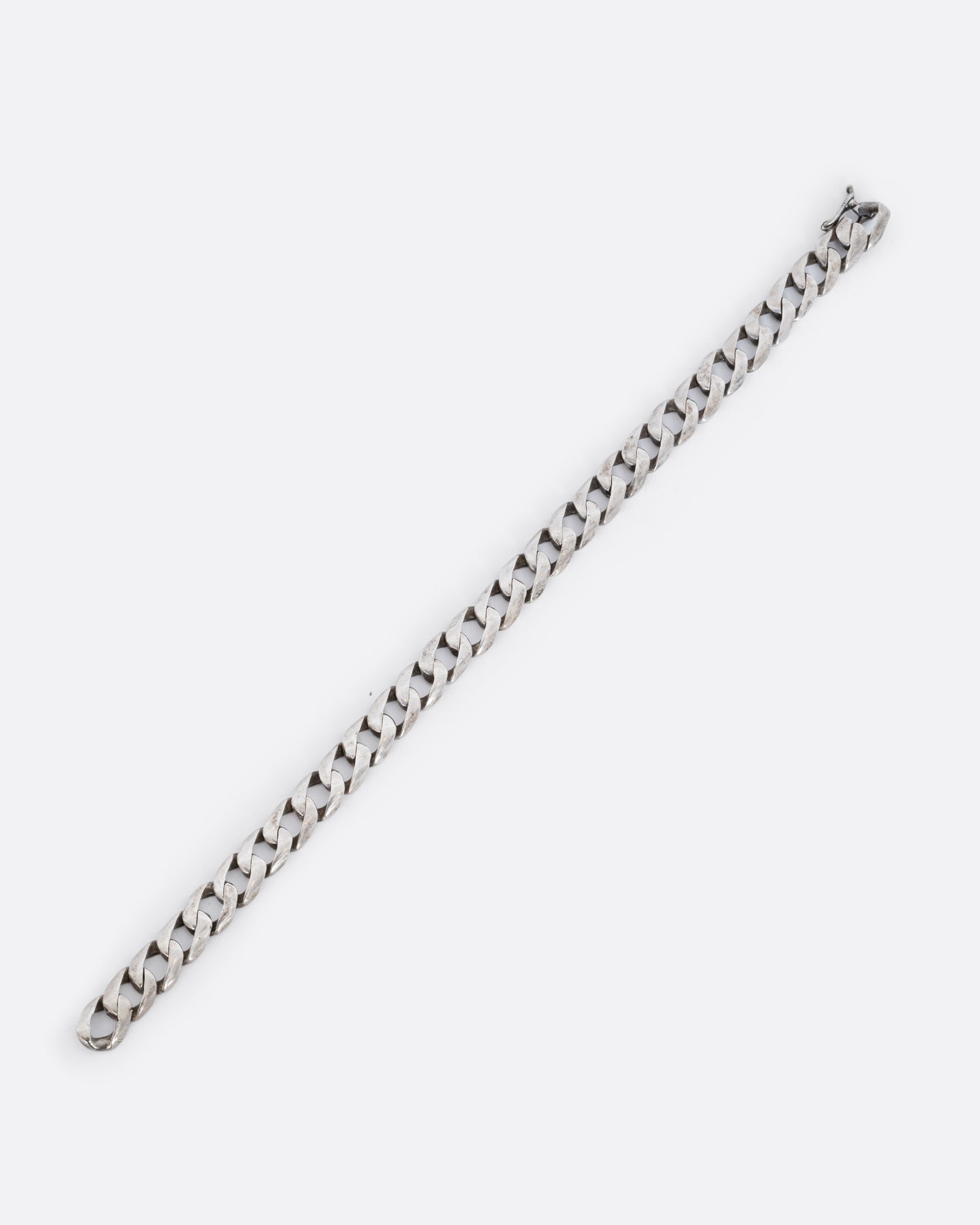 Sterling silver flat curb chain bracelet. Shown laying flat.