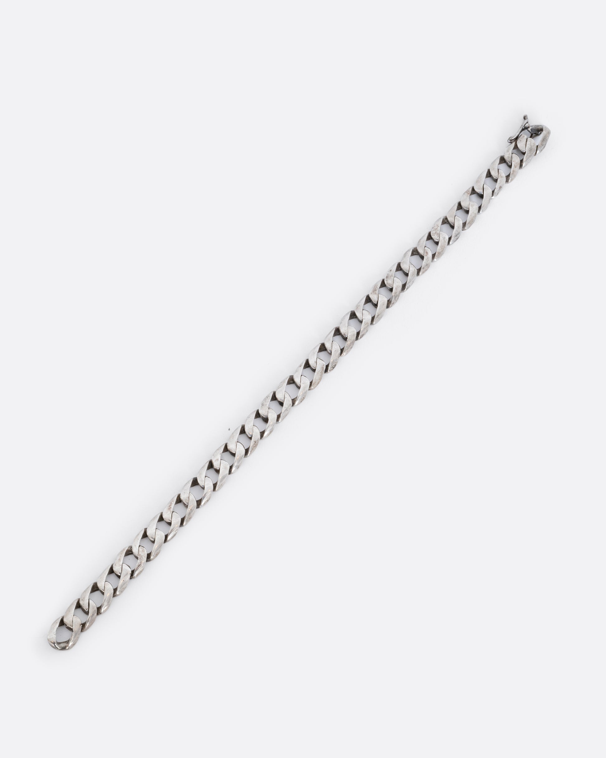 Sterling silver flat curb chain bracelet. Shown laying flat.