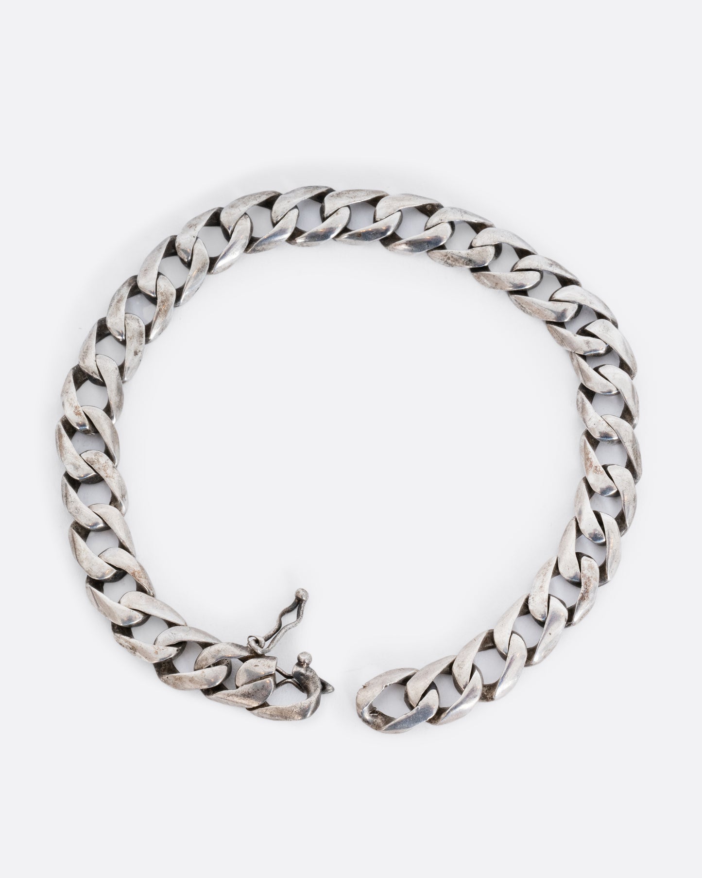 Sterling silver flat curb chain bracelet. Shown from above, open.