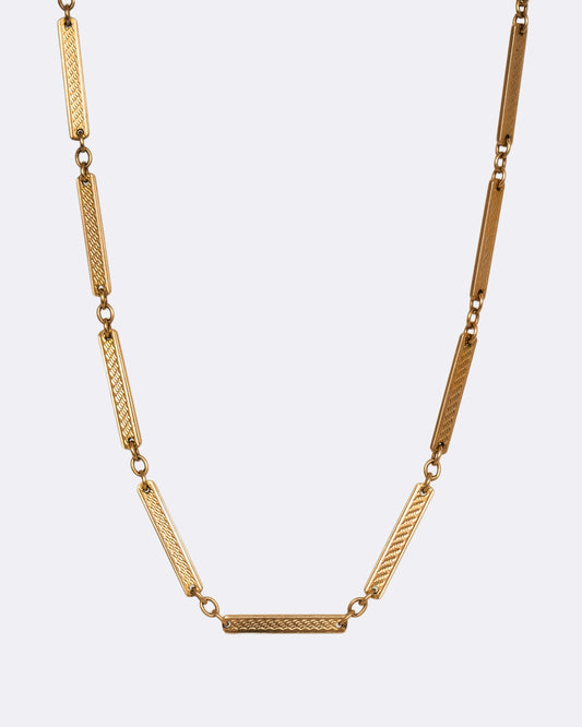 A yellow gold watch chain with textured elongated bar links. View from the front.