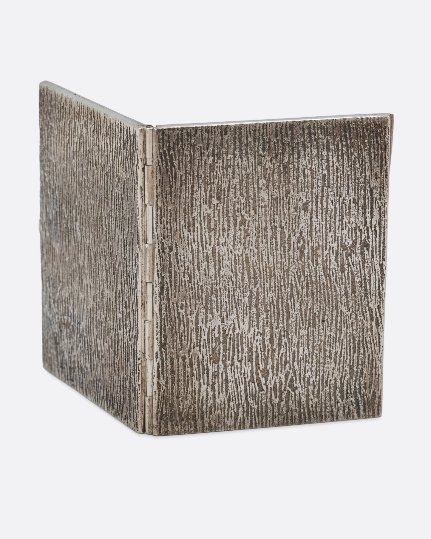 A silver picture frame with a textured exterior with two spots for photos, shown open from the back.