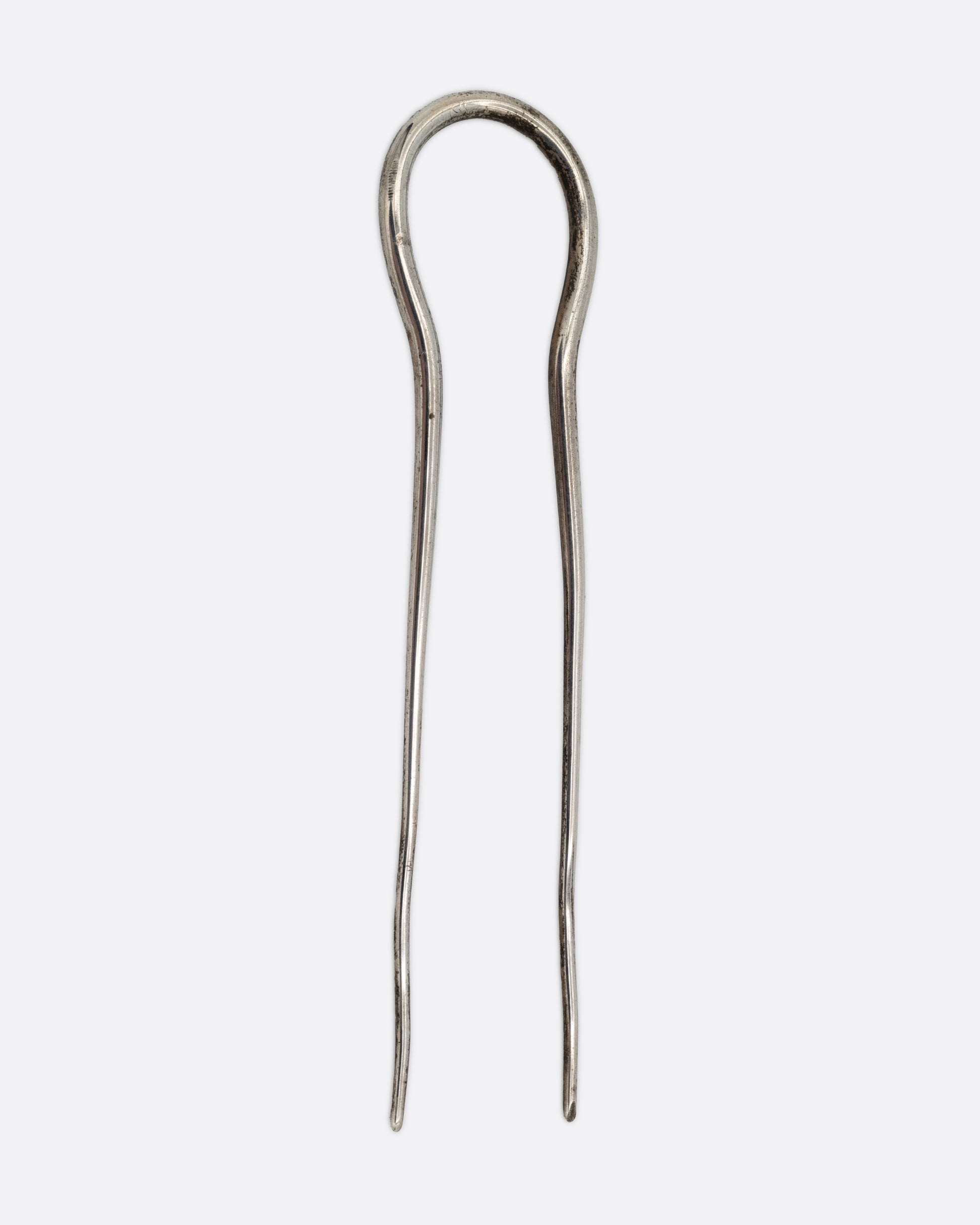 A silver hair pin with an arch at the top, shown from the front.