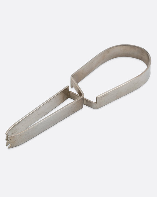 Stainless steel ice tongs with an arched handle, shown on their side.