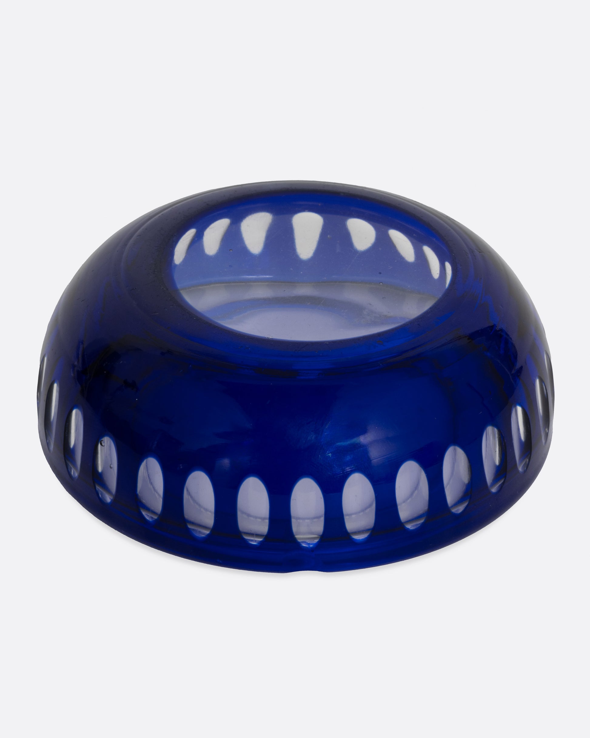 A blue glass ashtray with a bubbly design, shown from the bottom.