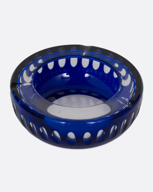 A blue glass ashtray with a bubbly design, shown from the top.