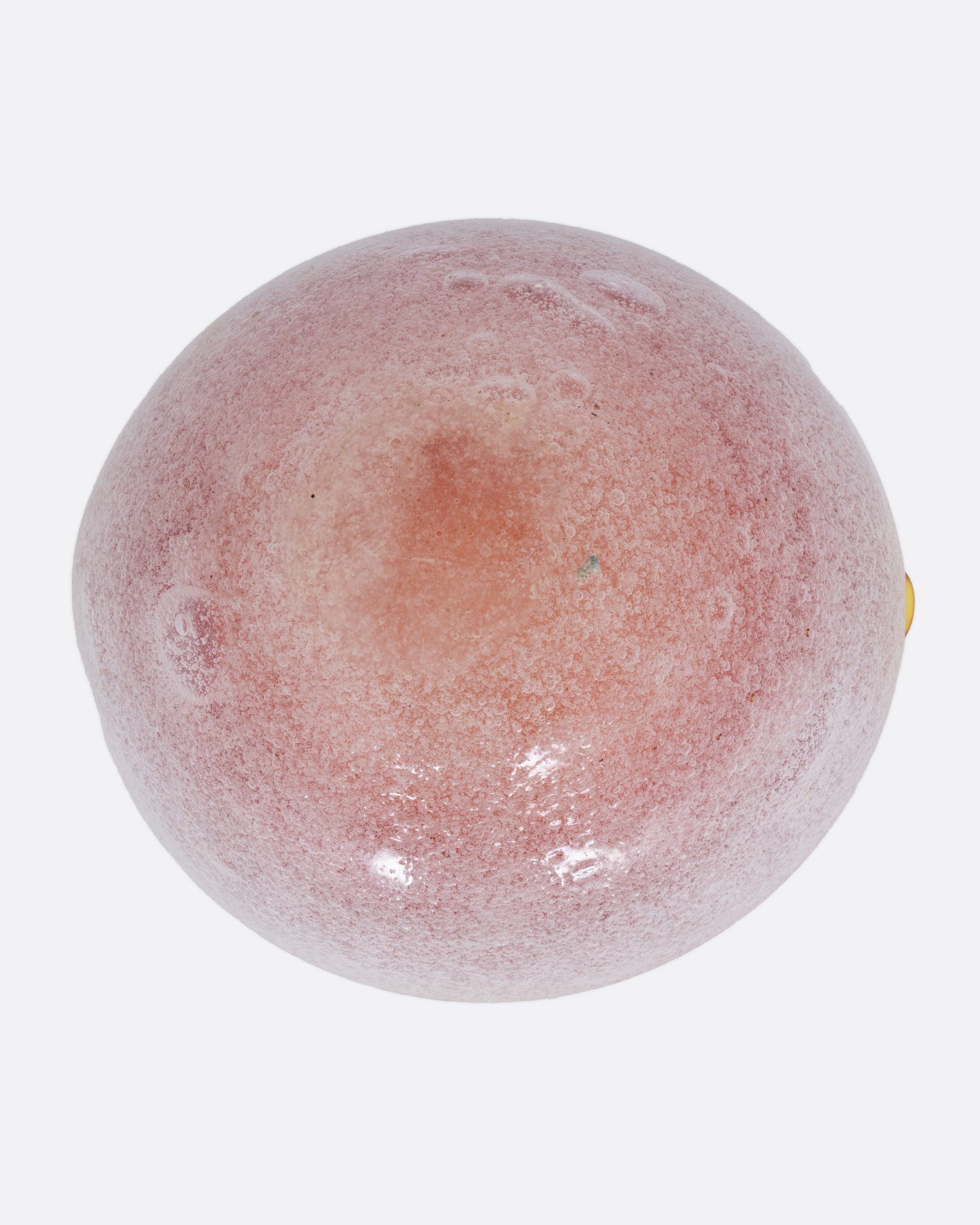 An orange and white blown glass ashtray, shown from the bottom.