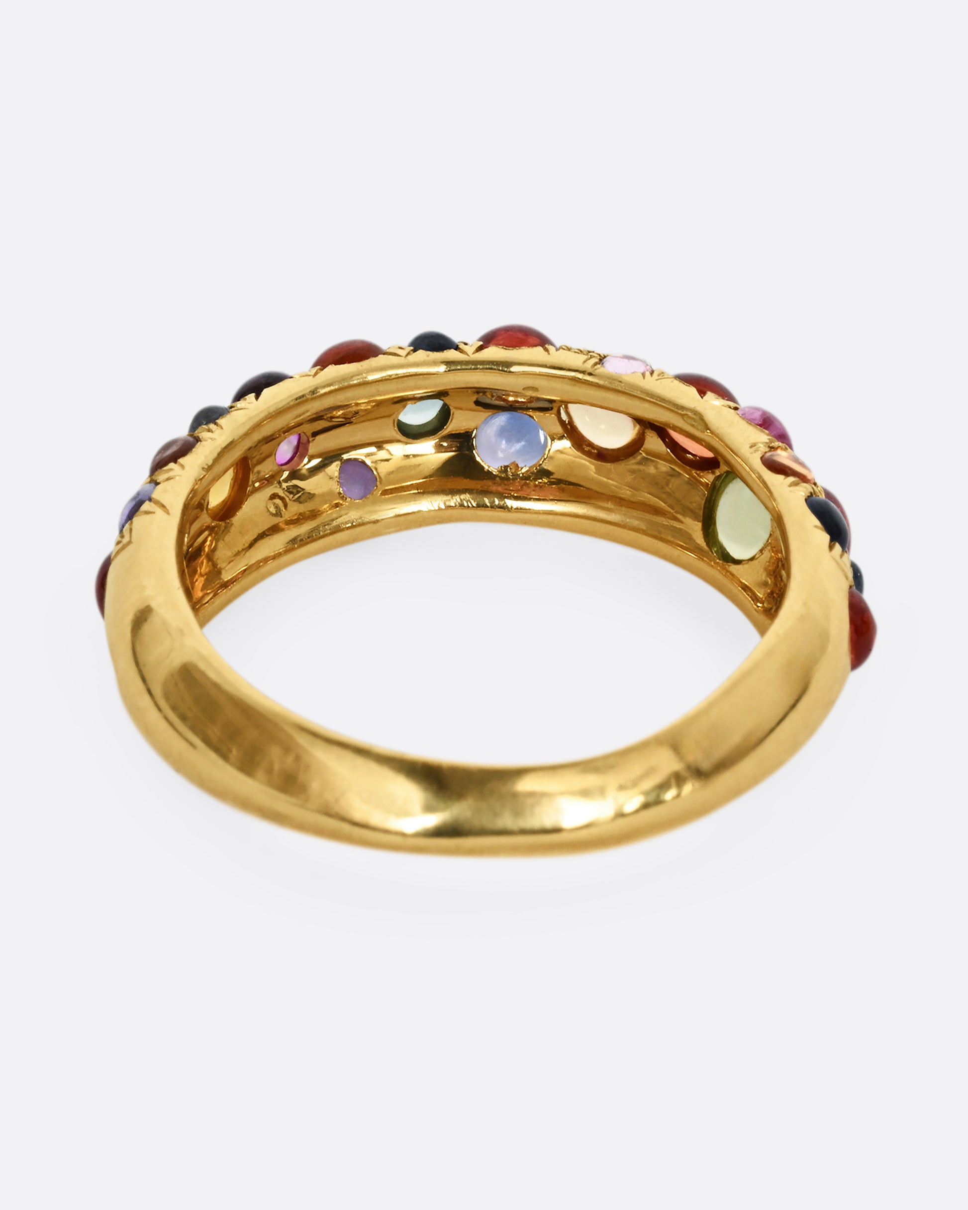 Multicolor sapphire cabochons set in an 18k yellow gold band. Shown from the back.