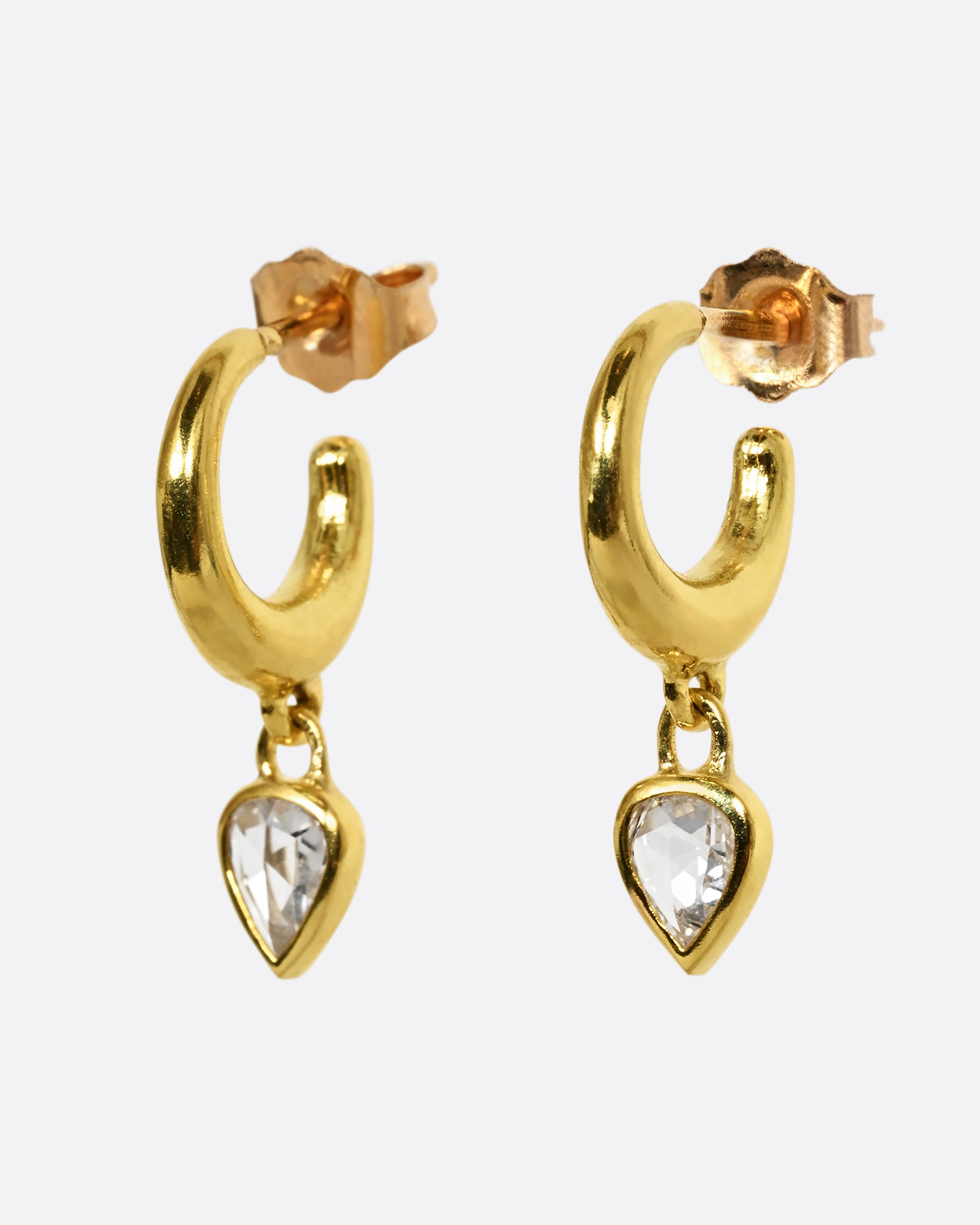 A yellow gold hoop earring with a diamond dangle, shown from the side, as a pair.