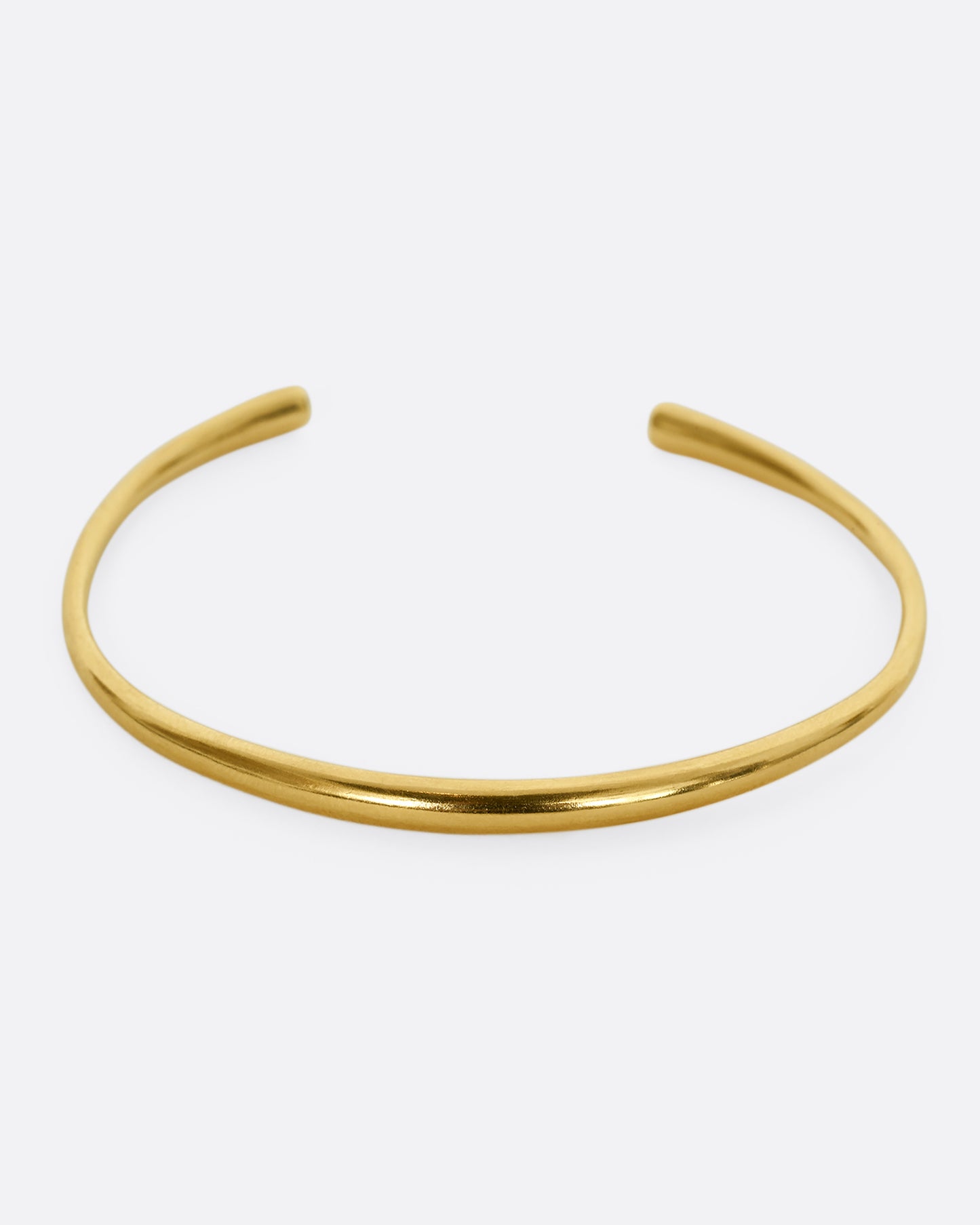 A yellow gold cuff bracelet. Shown from the front.