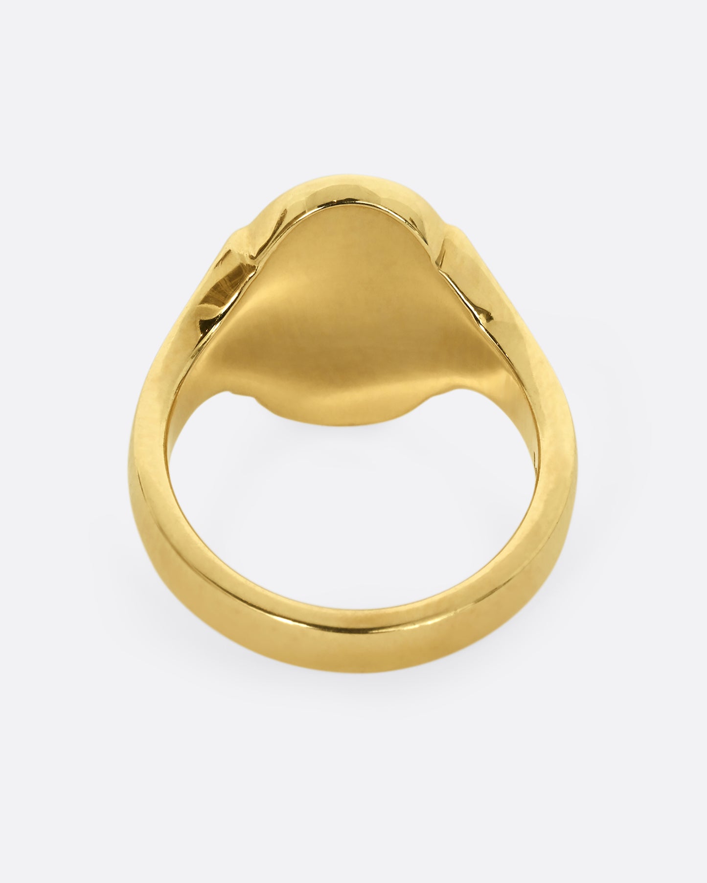 A yellow gold signet ring with blue enamel and the letter "M". Shown from the back.