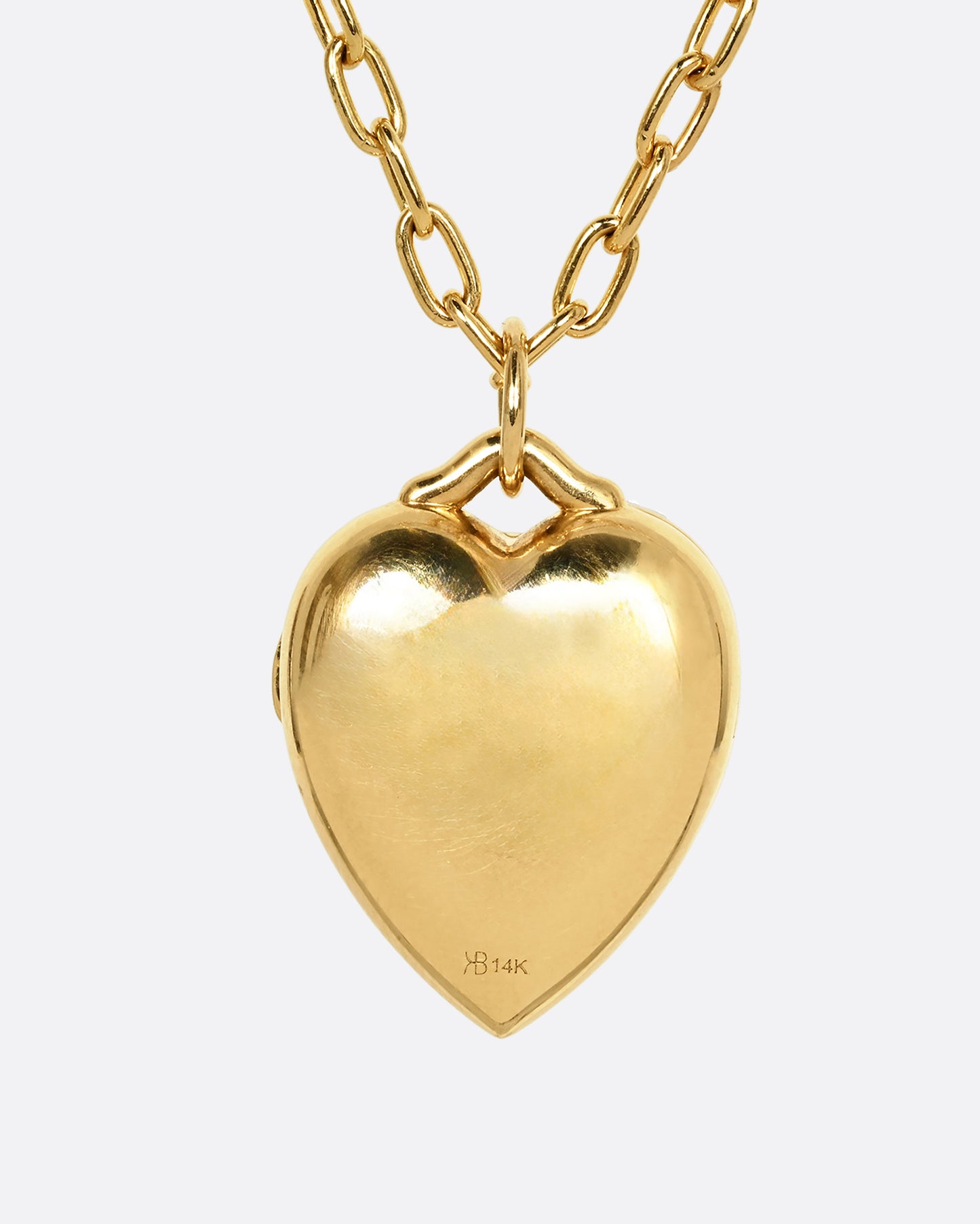 A yellow gold heart shaped locket with a multicolor floral motif on a heavy chain. Shown from the back.