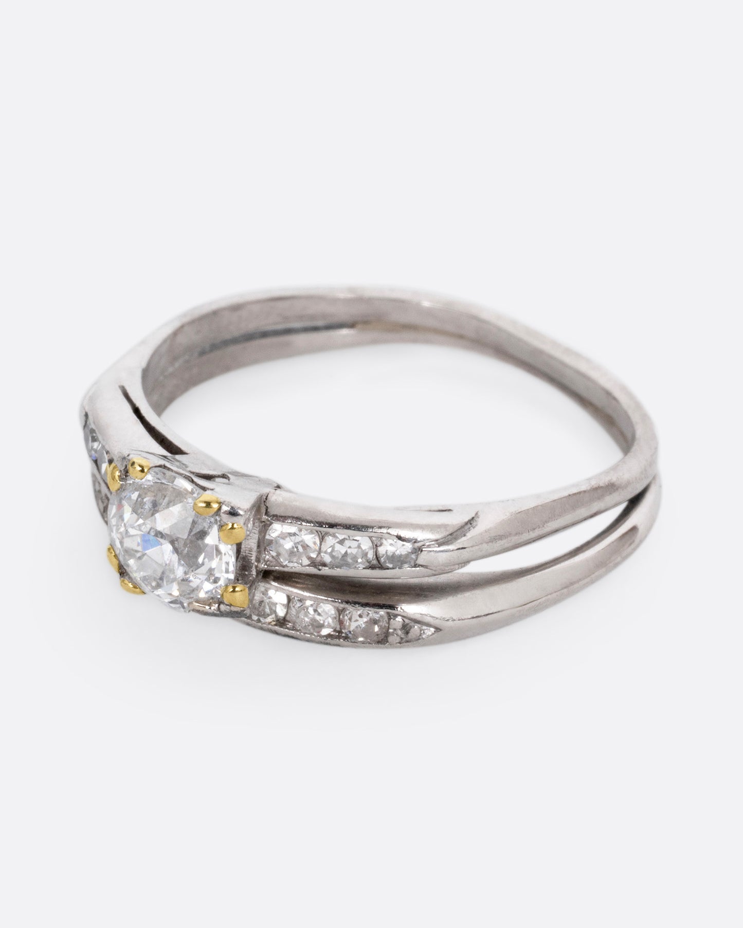 A platinum ring with an Old European cut diamond and a split shank, shown from the side.